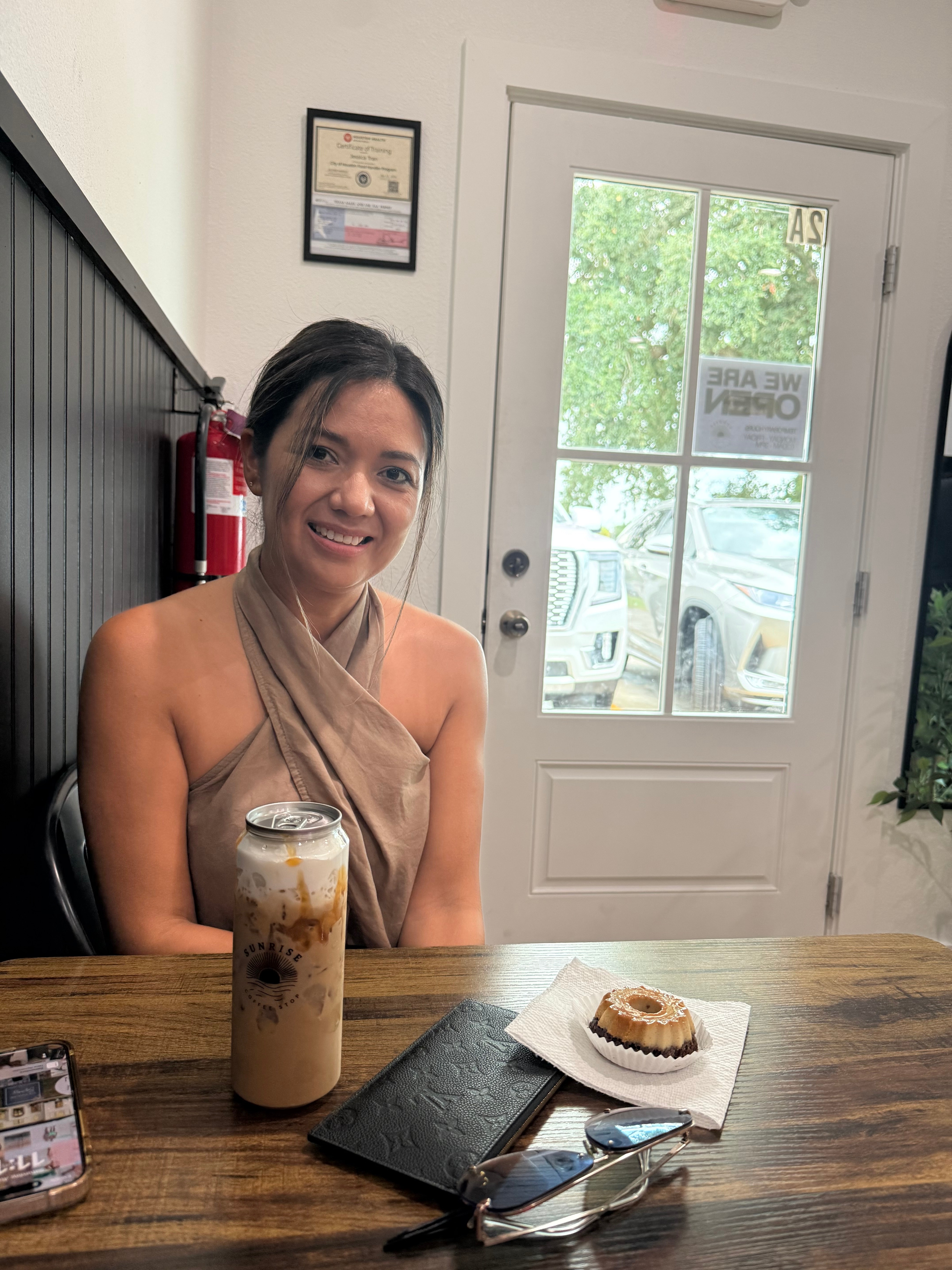 A guest with an iced latte and a bundt cake
