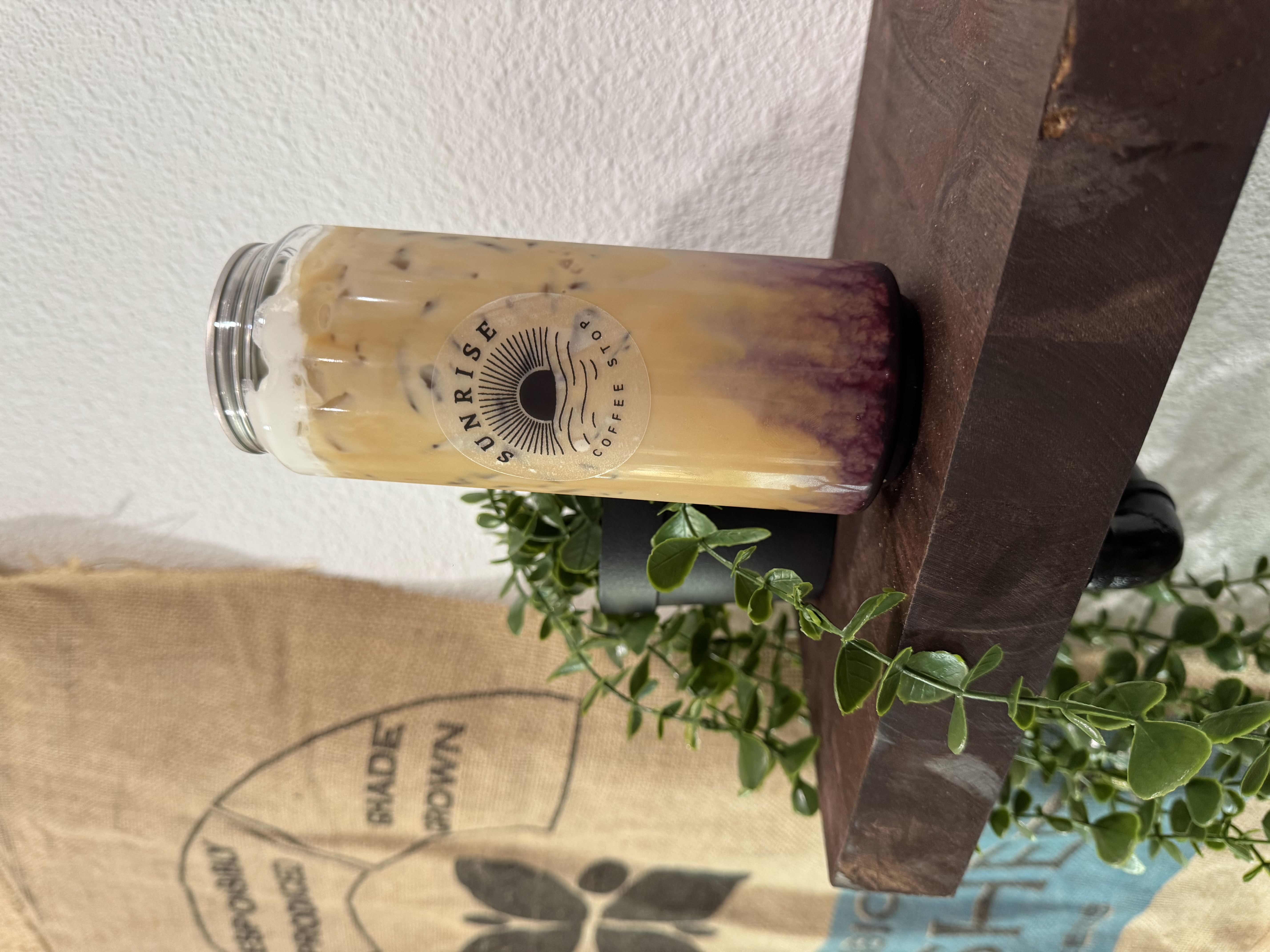A branded Sunrise Coffee Stop canned latte on a shelf